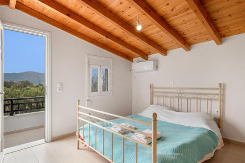 a bedroom with a bed and a balcony at Angelina's Cute House in Neapoli Voion