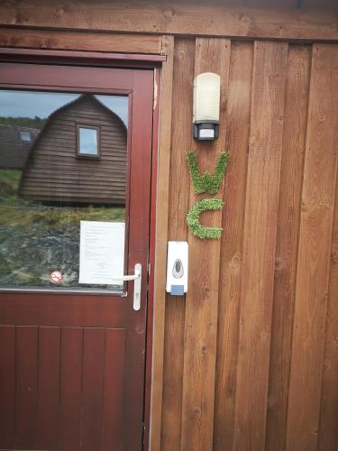a door to a house with a cactus on it at The Gather - Tarbert Argyll in Tarbert