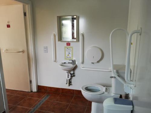 a bathroom with a toilet and a sink at The Gather - Tarbert Argyll in Tarbert