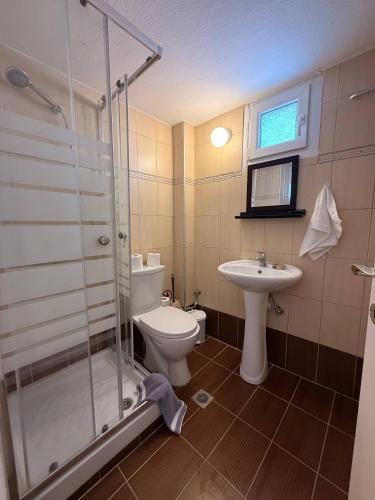 a bathroom with a shower and a toilet and a sink at Helios in Kavála