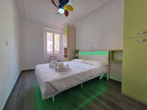 a bedroom with a bed with a ceiling fan at Arlecchino - By Turent in Pietra Ligure