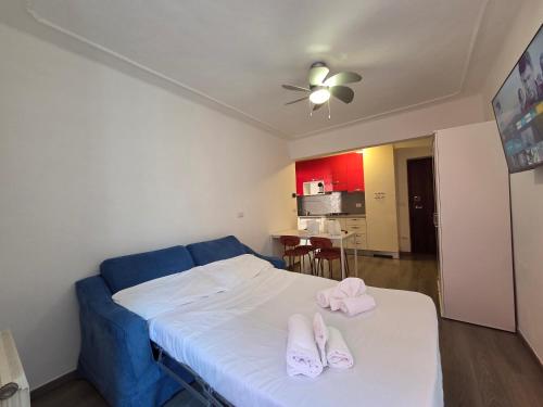 a bedroom with a bed with two slippers on it at Arlecchino - By Turent in Pietra Ligure