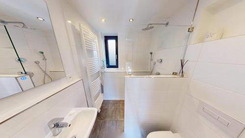 a bathroom with a sink and a toilet and a tub at Tschuggen TU14 in Blatten bei Naters
