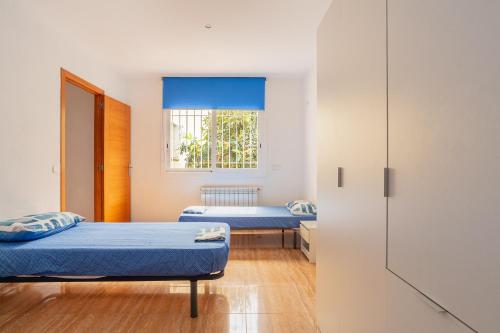 a room with two beds and a window at Villa Florida in Lloret de Mar