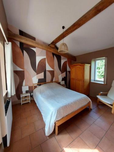 a bedroom with a large bed in a room at Gîte Rabanier in Saint-Ciers-dʼAbzac