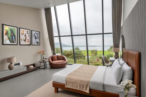 a bedroom with a large bed and a large window at Beyond by Sula in Nashik