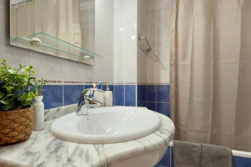 a bathroom with a white sink and a mirror at Casa da Rosa by Mth in Porto Santo