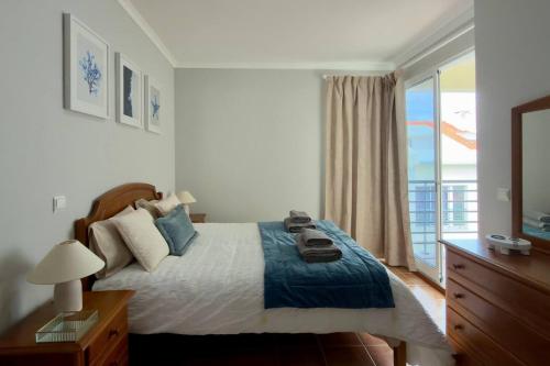 a bedroom with a bed and a large window at Casa da Rosa by Mth in Porto Santo