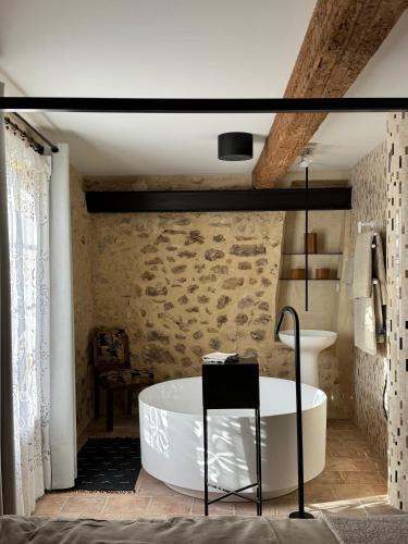 a bathroom with a bath tub and a sink at Domaine de Ribaute in Lieuran-lès-Béziers