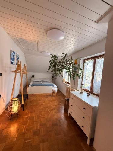 a bedroom with a bed and a wooden floor at Green Breeze - Private Hot Tub Retreat in Žalec