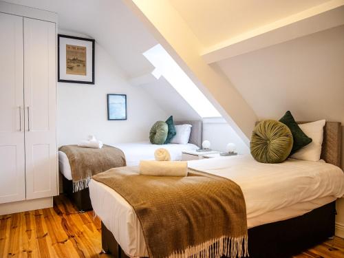 a bedroom with two beds in a attic at Apartments in Dingle Town Center in Dingle