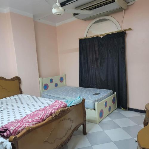 a bedroom with two beds and a window at OS & MA Luxor in Luxor