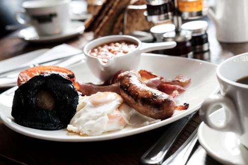 a plate of breakfast food on a table at The Fox & Goose Hotel in London
