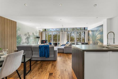 a kitchen and living room with a couch and a table at Designer Apartment in Central Lincoln - Sleeps 8 in Lincoln