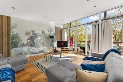 a living room with a couch and a tv at Designer Apartment in Central Lincoln - Sleeps 8 in Lincoln