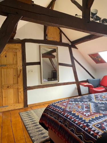 a bedroom with a bed and a mirror in a room at 't Wirkes in Schimmert