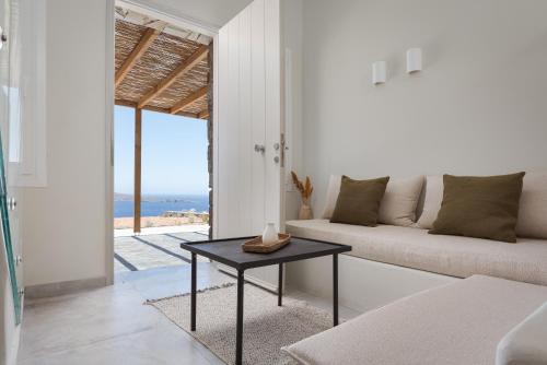 a living room with a couch and a table at Kythea Suites Kythnos in Kithnos
