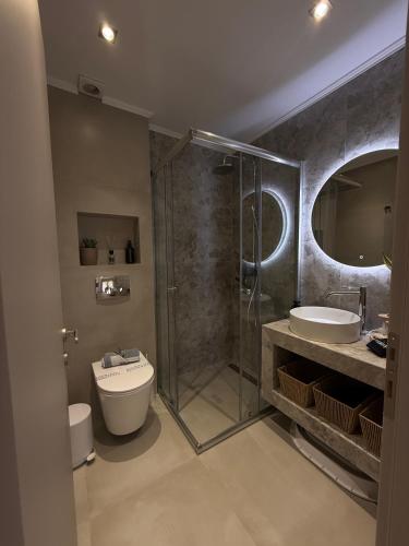 a bathroom with a shower and a toilet and a sink at Nido Estivo 1 in Nea Skioni
