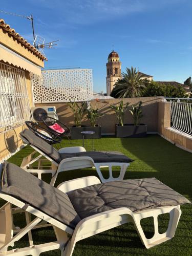 a patio with chairs and a table on a roof at Apartamento en Lorca Murcia in Lorca