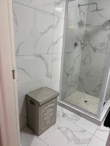 a bathroom with a shower with a box on the floor at 3 on Eland in Vryheid
