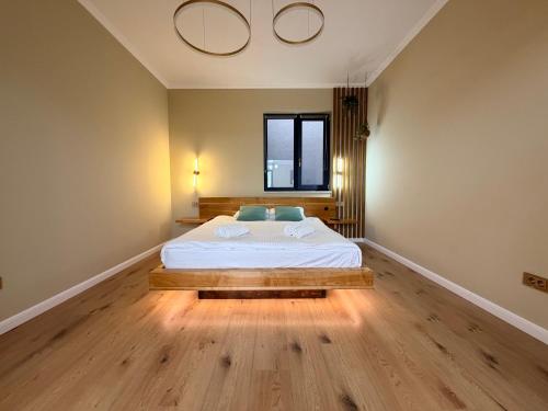 a bedroom with a bed and a window at Ophir Apartment Ultracentral,the greenest and brightest central area,3 parking space in the large yard in Cluj-Napoca