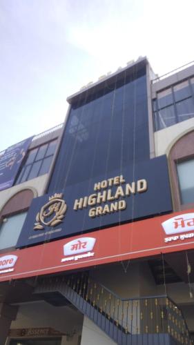 a hotel highland grandstand sign on the side of a building at Hotel highland grand in Zirakpur