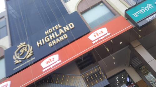 a sign on the front of a building at Hotel highland grand in Zirakpur