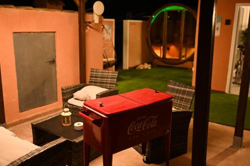a living room with a cocacola table and chairs at Villa Preciosa de Luxe and Spa in Mazarrón