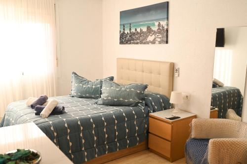 a bedroom with a bed with blue pillows on it at Villa Preciosa de Luxe and Spa in Mazarrón