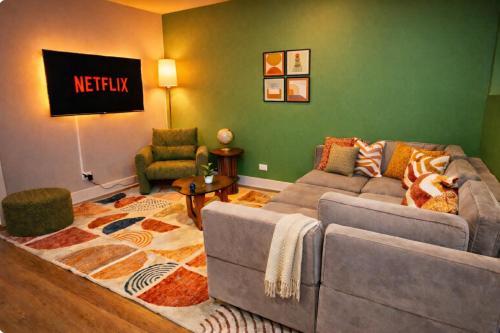 a living room with a couch and chairs and a sign at Cozy 3BR Chicago Garden Apartment Near Loyola & Downtown in Chicago