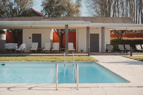 a swimming pool in front of a house at ARTS IN Country House in Tondela
