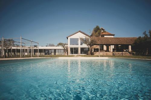 a large pool of water in front of a house at ARTS IN Country House in Tondela