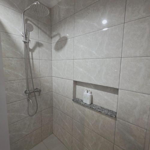 a shower with a glass door in a bathroom at Sunflower Residences Capitol in Cebu City