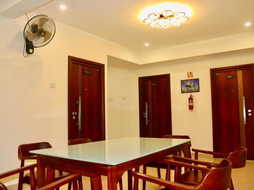 a dining room with a table and chairs at Waves Residency in Chennai