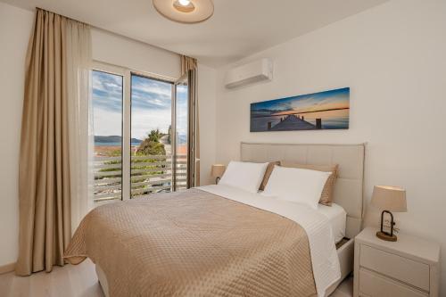 a bedroom with a bed and a large window at Adriatic Sea Escape B20 in Herceg-Novi