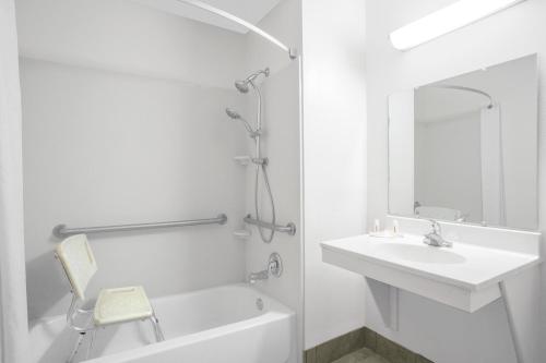 a white bathroom with a sink and a bath tub at Super 8 by Wyndham Abingdon VA in Abingdon