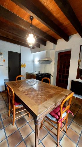 a wooden table in a kitchen with chairs around it at Chalet chateau verdun in Château-Verdun