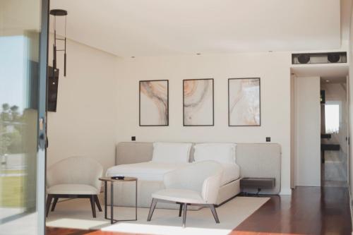 a living room with two chairs and a couch at ARTS IN Country House in Tondela