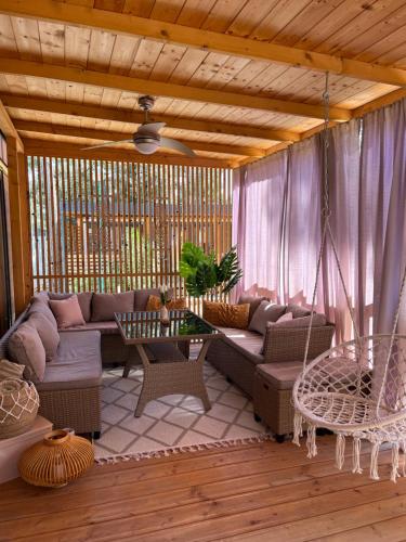 a living room with a couch and a swing at Mobile Home Sea Heaven in Biograd na Moru