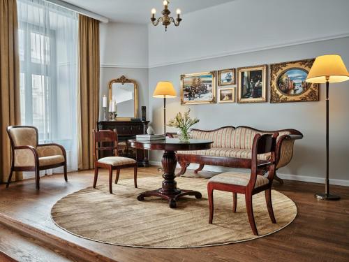a living room with a table and chairs at Hotel President in Bielsko-Biała