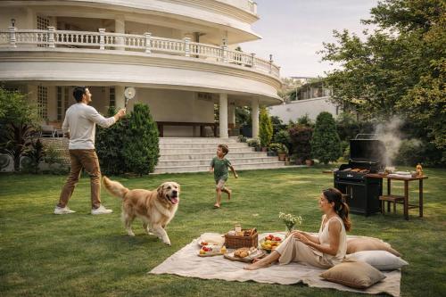 a man and a woman and a dog playing with a frisbee at Boutique Villa w Bonfire & BBQ, Mussoorie Foothills in Dehradun