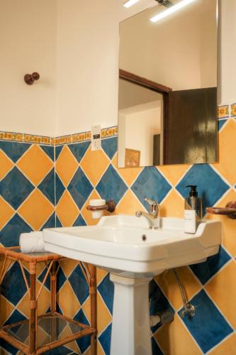 a bathroom with a sink and a mirror at Historic Villa with a Private Pool in Mosta
