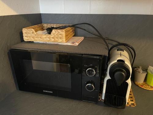 a microwave with a camera on top of it at Il Mulino - Bilocale in centro in Ponte di Legno