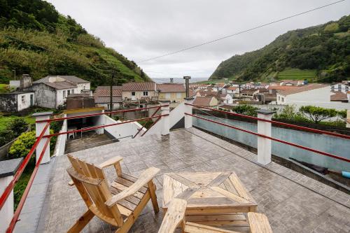 a couple of chairs sitting on a balcony at Casa Girasol in Faial da Terra