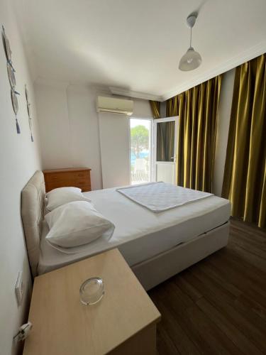 a bedroom with a large bed and a window at Tiffany Otel in Özdere