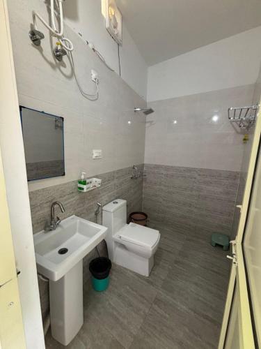 a bathroom with a sink and a toilet at The Jade Inn in Gopeshwar