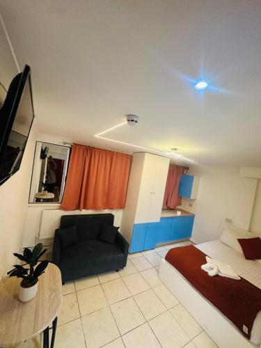 a living room with a couch and a table at Modern Studio Apartments in Bromley, Greater London near Tesco and Sundridge Park Station in Bromley