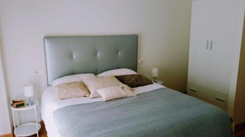 a bedroom with a large bed with two pillows at El Rincón del Ángel in Jaca