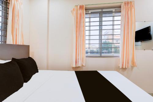 a bedroom with a bed and a large window at Townhouse MVP Sector With Kailasagiri Hill View in Visakhapatnam