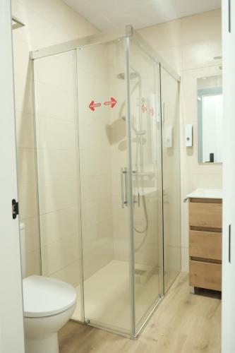 a glass shower in a bathroom with a toilet at Balcones a San Pedro in Osuna